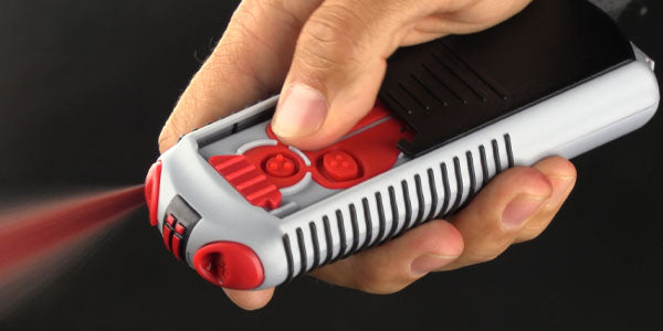 A hand pressed the firing button on the AIIRO. Red gel is bursting from the device.