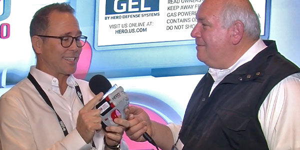 A man with a microphone interviews another man who is holding a HERO 2020